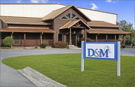 A large building with a D&M sign in front of it.	